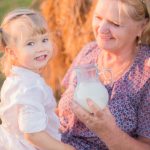Grandma treats her granddaughter milk in a haystack