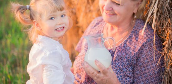 Grandma treats her granddaughter milk in a haystack