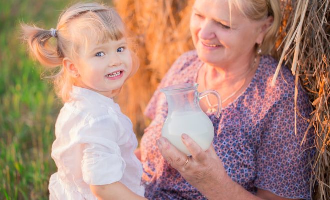 Grandma treats her granddaughter milk in a haystack